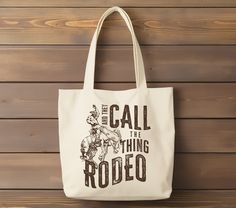 "Rodeo Canvas Tote Bag | Cowboy Reusable Bag | Bucking horse Western gift | Cowgirl Rodeo fashion They Call the Thing Rodeo Western tote bag This 100% cotton bag comes in one size - 15\" x 16\"- perfect for everyday wear. The bag features 20\" handles (made from the same canvas), making it easy to carry even with a week's worth of shopping. .: 100% cotton canvas .: Heavy fabric .: Sewn-in label .: Made to order" Western Tote Bags, Bucking Horse, Horse Western, Cowgirl Rodeo, Western Gifts, Rodeo Fashion, Canvas Making, Reusable Bags, Canvas Tote Bag