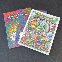 two coloring books sitting next to each other on top of a black surface with the title, mashup and doodles