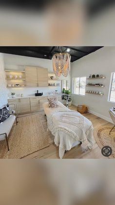 this is an image of a bedroom with a bed and chandelier hanging from the ceiling