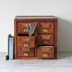 a wooden desk with drawers and a book