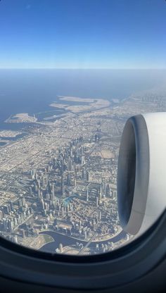 an airplane window looking out at the city