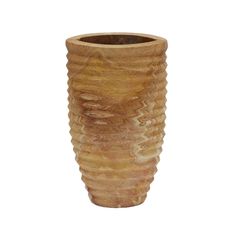 a tall wooden vase sitting on top of a white surface