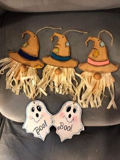 three little witches are hanging from the back of a car seat, one is decorated with fringe