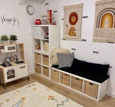 a living room with white walls and lots of storage space on the wall next to it