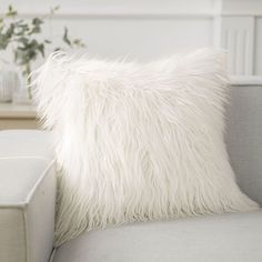 a white pillow sitting on top of a couch