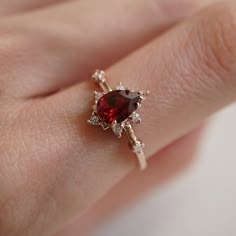 A beautiful garnet set in solid sterling silver with a layer of thick 14k yellow gold. The gorgeous ring for an understated classy look. Available in yellow gold vermeil, rose gold and silver, or 14K solid gold. Pair it with our ring bands to create the ultimate royal stack. Gold vermeil or 14K solid gold 7x5mm natural pear-shaped garnet stone Round CZs (what's this?) ** This item is specially made for you. Please allow 1-2 week lead time. ShippingDomestic: Free standard shipping within the U.S. Vintage Engagement Rings Garnet, Ruby Engagement Rings, Ruby Wedding Ring, Garnet Wedding Rings, Ruby Ring Vintage, Ruby Wedding Rings, Garnet Wedding, Garnet Engagement Ring, Red Rings