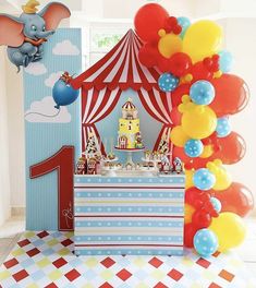 a circus themed birthday party with balloons, cake and decorations for an elephant 1st birthday