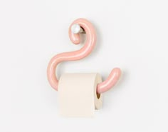 a roll of toilet paper hanging from a hook on a wall with a white background