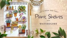 an open notebook sitting on top of a wooden table next to potted plants and greenery