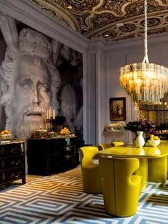 an image of a dining room with yellow chairs and chandelier on the ceiling