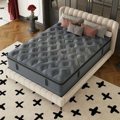 a large bed sitting on top of a wooden floor next to a white and black rug