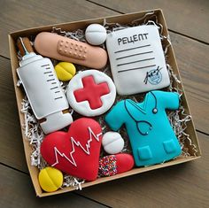 decorated cookies in a box with medical symbols and stethoscopes on them