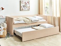 a twin bed with two trundle beds underneath it