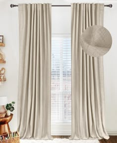 a living room with white walls and curtains