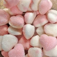 pink and white candy hearts are in a bowl