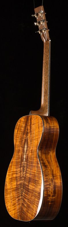 an acoustic guitar is shown against a black background with the strings still attached to it