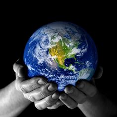 two hands holding the earth in black and white