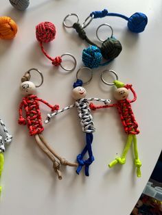 several keychains made to look like people holding hands