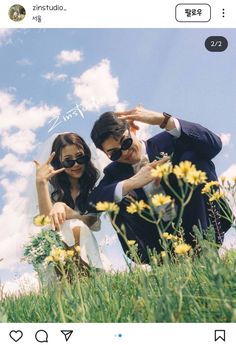 a man and woman posing for a photo in the grass