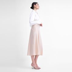 Introducing our exquisite Satin Midi Skirt, a timeless piece designed to elevate your style with sophistication and grace. This midi-length skirt features a flared hemline that exudes elegance and movement. Its high-waisted design offers a flattering silhouette that complements various body types. Crafted with meticulous attention to detail, the concealed zip fastening ensures a seamless finish, allowing for easy wear while maintaining a polished look. While offering no stretch, its structured design maintains its shape, adding a touch of refinement to your ensemble. Dry clean only Luxury Elegant Midi-length Skirt, Luxury Satin Knee-length Skirt, Beige Silk Relaxed Skirt, Beige Flowy Midi-length Skirt, Non-stretch Beige Midi Skirt, Satin Midi Skirt, April Birthstone Jewelry, March Birthstone Jewelry, Midi Length Skirts