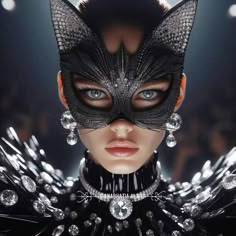 a woman wearing a black cat mask with jewels on her head and an elaborate choker around her neck