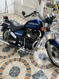 a blue motorcycle parked on top of a tiled floor