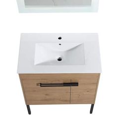 a white sink sitting next to a wooden cabinet