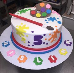 a birthday cake decorated with paint and numbers