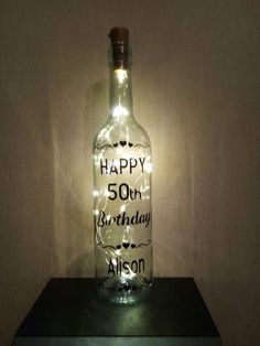 a bottle that is sitting on top of a table next to a light up sign