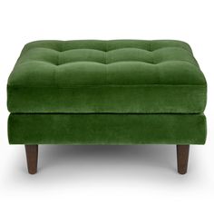 a green footstool sitting on top of a white floor