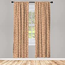 a room with a wooden floor and two giraffe print curtains