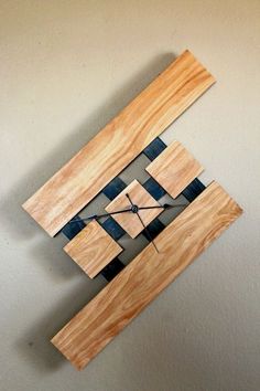 a clock made out of wood with black and white squares on the face is shown