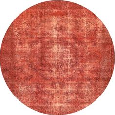 a round rug with an orange and red design on the center, in front of a white background