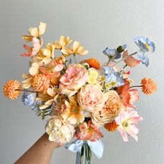 a vase filled with lots of different colored flowers