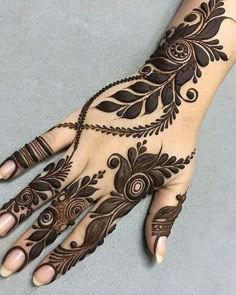 a woman's hand is decorated with hennap and intricate designs on it