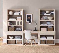 a white chair sitting in front of a book shelf filled with books and other items