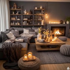 a living room filled with furniture and candles