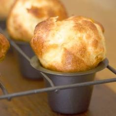 three muffins sitting on top of a metal rack