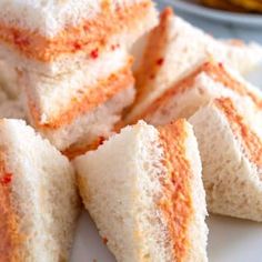 several pieces of bread stacked on top of each other with sauces in the background