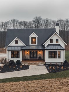 a white house with black roof and windows