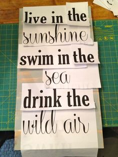 three pieces of paper that have been cut out to spell the words live in the sunshine, swim in the sea, and drink the wild air