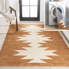 a yellow and white rug in a room with a washer, dryer and chair