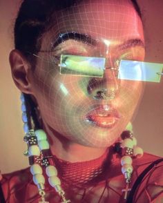 a woman with futuristic glasses and necklaces on her face