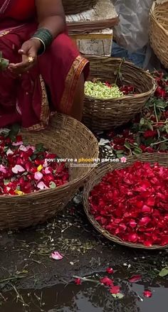 baskets filled with flowers sitting on top of a wet ground next to other baskets full of petals