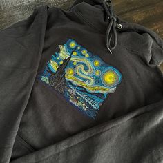 This sweatshirt is not only a soft garment to keep you comfortable, but a canvas that displays the timeless beauty of Vince Van Gogh's iconic masterpiece. The detailed embroidery was both designed and stitched in-house. Whether you're looking for a wearable conversation starter for yourself, or a unique gift for a loved one, the Starry Night Sweatshirt is guaranteed to satisfy! Select a color that specifies 'Crewneck' or 'Hoodie' to choose your garment type. Sweatshirt Specifications - 7.8 ounce, 50/50 Cotton/Polyester Fleece - Air jet yarn for softness - Classic fit Each embroidered design is lined with soft comfort backing on the inside to reduce roughness Please allow up to 2-5 business days for processing and an additional 5-7 business days for shipping Please message us with any quest Artistic Cotton Sweatshirt For Winter, Crewneck Embroidery, Stitch Hoodie, Detailed Embroidery, Embroidery Sweater, The Starry Night, Embroidered Sweatshirt, Embroidered Hoodie, Embroidered Sweatshirts