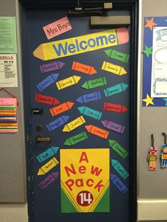 a door decorated with colorful papers and magnets that read, welcome a new pack