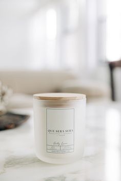 a white candle sitting on top of a table