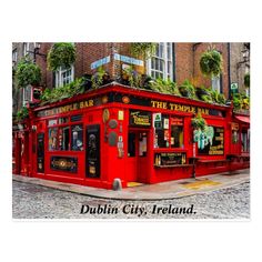 there is a red building that has plants on it and the words dublin city, ireland