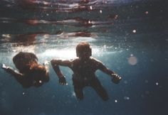 a man swimming under water in the ocean