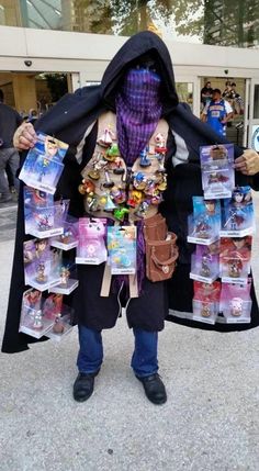 a man in costume is holding up some toys